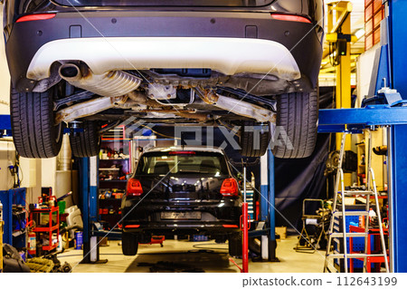 Car lifted in automobile service 112643199
