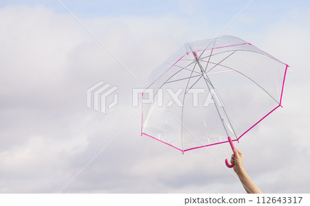 Hand holding transparent umbrella outdoor 112643317