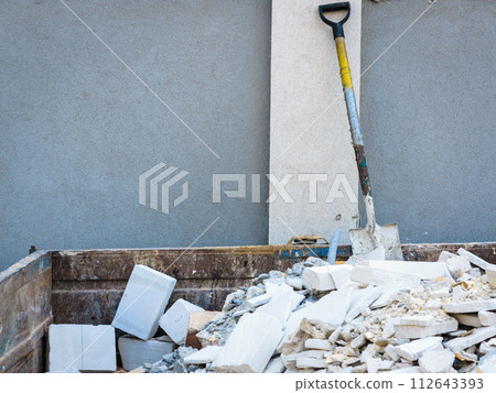 Spade in pile of rubble. Spade in pile of rubble. 112643393