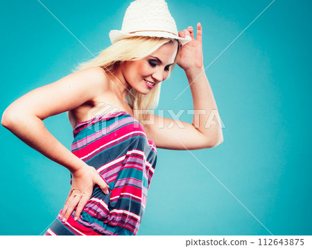 Blonde woman wearing short colorful striped dress 112643875