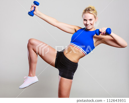 Fit woman lifting dumbbells weights Fit woman lifting dumbbells weights 112643931