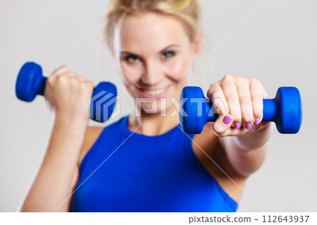 Fit woman lifting dumbbells weights Fit woman lifting dumbbells weights 112643937