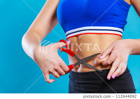 Woman pinching waist for skin fold test Woman pinching waist for skin fold test 112644092