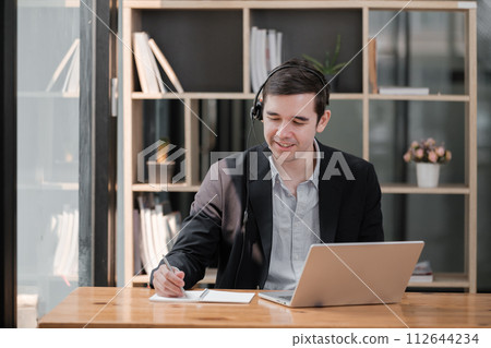 Handsome well dressed businessman working at his office, businessman working on a project 112644234