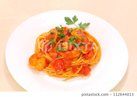 Shrimp and tomato pasta, white plate, Italian parsley Shrimp and tomato pasta, white plate, Italian parsley 112644813