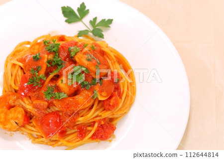 Shrimp and tomato pasta, white plate, Italian parsley 112644814