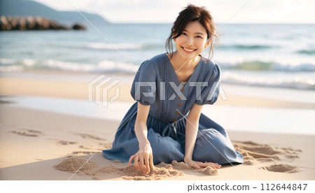 一個女人坐在沙灘上 112644847