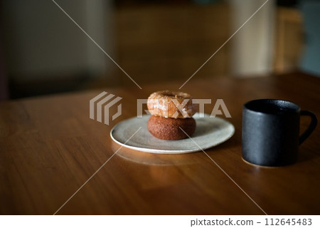 Coffee time with two stacked donuts as a snack Coffee time with two stacked donuts as a snack 112645483