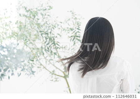 Beauty hair care image of a young woman with flowing green hair that has an organic or natural image. Rear view without a face. Beauty hair care image of a young woman with flowing green hair that has an organic or natural image. Rear view without a face. 112646031