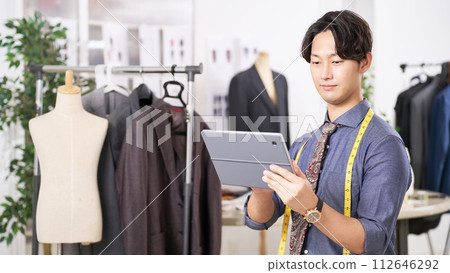 Apparel designer holding a tablet Apparel designer holding a tablet 112646292