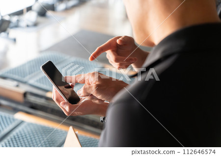 男教練在健身房/私人健身房檢查智慧型手機螢幕的手 112646574