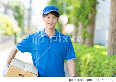 A courier male driver delivering a package 112648889
