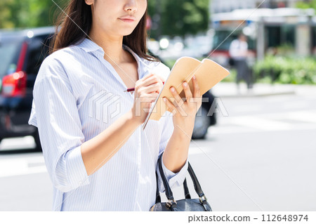 Business woman with a notebook Business woman with a notebook 112648974