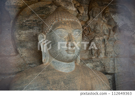 Beautiful face of small Buddha statue located inside the artificial cave named the "Vidyhadhara Guha" at Gal Vihara in Polonnaruwa ancient city of Sri Lanka. 112649363
