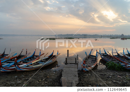 U Bein Bridge with lake, Wooden Bridge in Mon village, Myanmar or Burma, Asia. U Bein Bridge with lake, Wooden Bridge in Mon village, Myanmar or Burma, Asia. 112649645