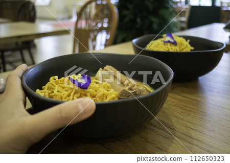 Thai noodles Khao Soi, spicy curry with seasoning on table Thai noodles Khao Soi, spicy curry with seasoning on table 112650323