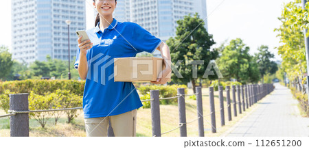 Young female courier staff carrying luggage Young female courier staff carrying luggage 112651200