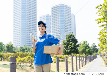 Young female courier staff carrying luggage Young female courier staff carrying luggage 112651201