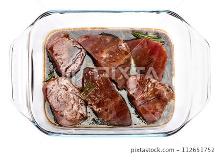 marinated Pieces of tuna Fish fillet in glass cooking dish isolated on white background 112651752