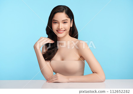 Beautiful young asian woman with clean fresh skin on blue background, Face care, Facial treatment, Cosmetology, beauty and spa, Asian women portrait. 112652282