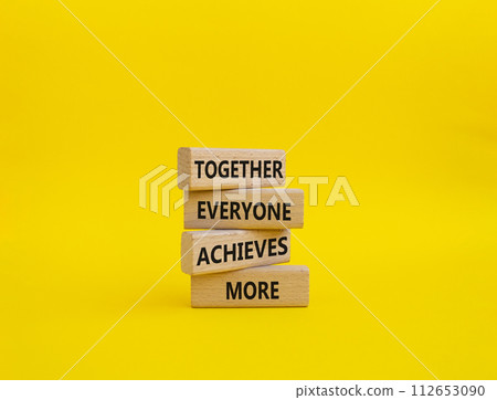 Together Everyone Achieves More symbol. Concept words Together Everyone Achieves More on wooden blocks. Beautiful yellow background. Business concept. Copy space. Together Everyone Achieves More symbol. Concept words Together Everyone Achieves More on wooden blocks. Beautiful yellow background. Business concept. Copy space. 112653090