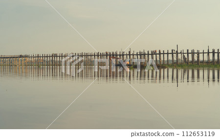 U Bein Bridge with lake, Wooden Bridge in Mon village, Myanmar or Burma, Asia. U Bein Bridge with lake, Wooden Bridge in Mon village, Myanmar or Burma, Asia. 112653119