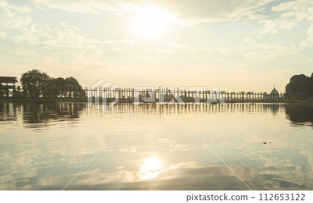 U Bein Bridge with lake, Wooden Bridge in Mon village, Myanmar or Burma, Asia. U Bein Bridge with lake, Wooden Bridge in Mon village, Myanmar or Burma, Asia. 112653122