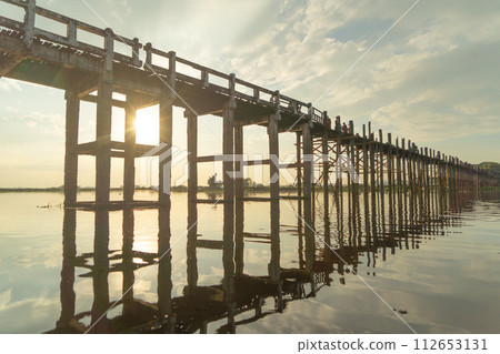 U Bein Bridge with lake, Wooden Bridge in Mon village, Myanmar or Burma, Asia. U Bein Bridge with lake, Wooden Bridge in Mon village, Myanmar or Burma, Asia. 112653131