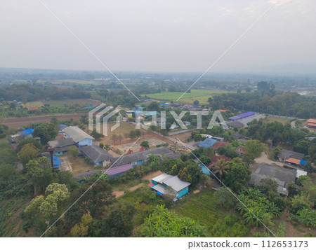 Aerial top view of lush green trees from above in tropical forest in national park in summer season. Natural landscape. Pattern texture background. Aerial top view of lush green trees from above in tropical forest in national park in summer season. Natural landscape. Pattern texture background. 112653173