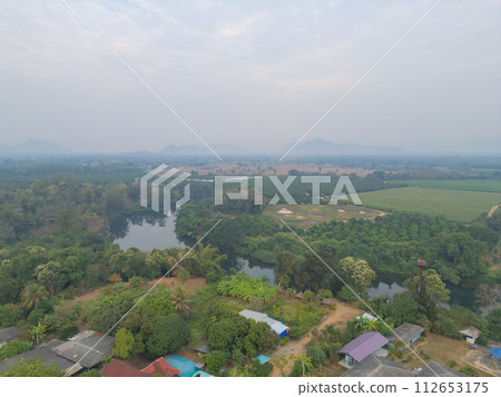 Aerial top view of lush green trees from above in tropical forest in national park in summer season. Natural landscape. Pattern texture background. Aerial top view of lush green trees from above in tropical forest in national park in summer season. Natural landscape. Pattern texture background. 112653175