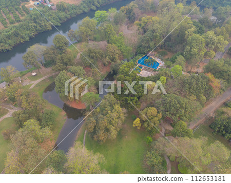 Aerial top view of lush green trees from above in tropical forest in national park in summer season. Natural landscape. Pattern texture background. Aerial top view of lush green trees from above in tropical forest in national park in summer season. Natural landscape. Pattern texture background. 112653181