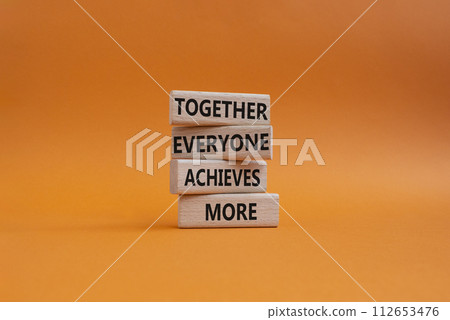 Together Everyone Achieves More symbol. Concept words Together Everyone Achieves More on wooden blocks. Beautiful orange background. Business concept. Copy space. 112653476