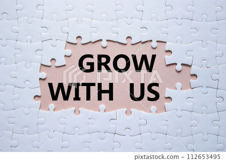 Grow with us symbol. Concept words Grow with us on white puzzle. Beautiful pink background. Business and Grow with us concept. Copy space. 112653495