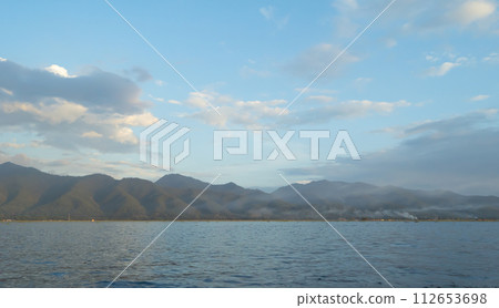 Sunset sky. Abstract nature background. Dramatic blue with orange colorful clouds in twilight time. 112653698