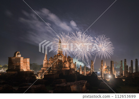 Fireworks celebration of Loy Krathong at Sukhothai Historical Park festival, buddha pagoda stupa in a temple, Sukhothai, Thailand. Thai buddhist temple architecture at night. Tourist attraction. 112653699