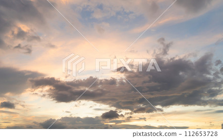 Sunset sky. Abstract nature background. Dramatic blue with orange colorful clouds in twilight time. Sunset sky. Abstract nature background. Dramatic blue with orange colorful clouds in twilight time. 112653728