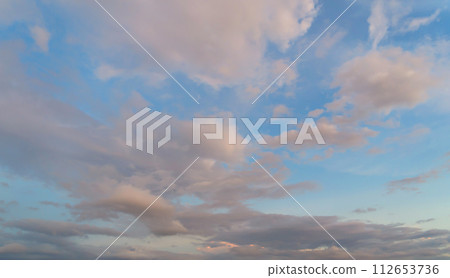 Sunset sky. Abstract nature background. Dramatic blue with orange colorful clouds in twilight time. 112653736