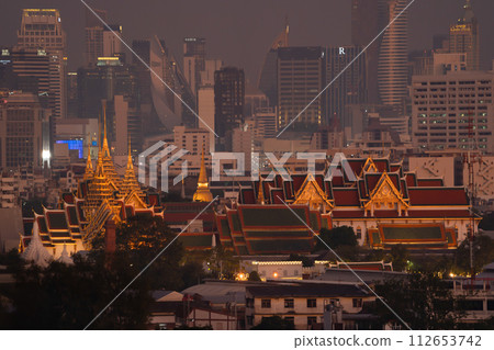 Golden pagoda at Temple of the Emerald Buddha in Bangkok, Thailand. Wat Phra Kaew and Grand palace in old town, urban city. Buddhist temple, Thai architecture. A tourist attraction. 112653742