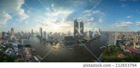 Aerial view of boats and Taksin Bridge with Chao Phraya River, Bangkok Downtown. Thailand. Financial district and business centers in smart urban city. Skyscraper and high-rise buildings. 112653794