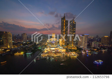 Aerial view of boats and Taksin Bridge with Chao Phraya River, Bangkok Downtown. Thailand. Financial district and business centers in smart urban city. Skyscraper and high-rise buildings. Aerial view of boats and Taksin Bridge with Chao Phraya River, Bangkok Downtown. Thailand. Financial district and business centers in smart urban city. Skyscraper and high-rise buildings. 112653798