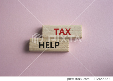 Tax Help symbol. Concept word Tax Help on wooden blocks. Beautiful pink background. Business and Tax Help concept. Copy space Tax Help symbol. Concept word Tax Help on wooden blocks. Beautiful pink background. Business and Tax Help concept. Copy space 112653862