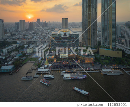 Aerial view of boats and Taksin Bridge with Chao Phraya River, Bangkok Downtown. Thailand. Financial district and business centers in smart urban city. Skyscraper and high-rise buildings. 112653901