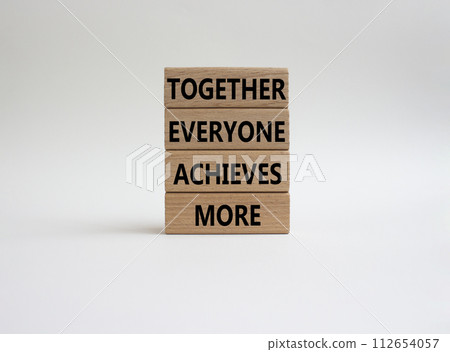 Together Everyone Achieves More symbol. Concept words Together Everyone Achieves More on wooden blocks. Beautiful white background. Business concept. Copy space. 112654057