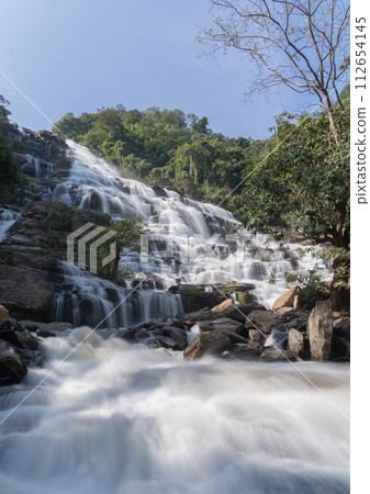 Mae Ya Waterfall, Doi Inthanon national park in Chiangmai, Thailand. Famous nature landscape background Mae Ya Waterfall, Doi Inthanon national park in Chiangmai, Thailand. Famous nature landscape background 112654145