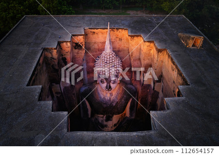 Aerial view of The buddha in Wat Si Chum in Sukhothai Historical Park, pagoda stupa, Sukhothai, Thailand. Thai buddhist temple architecture. Tourist attraction. 112654157