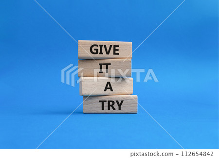 Give it a try symbol. Concept words Give it a try on wooden blocks. Beautiful blue background. Business and Give it a try concept. Copy space. 112654842