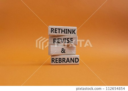 Rethink Revise and Rebrand symbol. Wooden blocks with words Rethink Revise and Rebrand. Beautiful orange background. Business and Rethink Revise and Rebrand concept. Copy space. 112654854