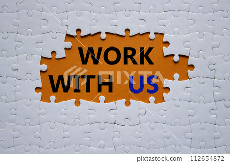 Work with us symbol. Concept words Work with us on white puzzle. Beautiful orange background. Business and Work with us concept. Copy space. 112654872