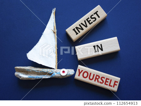 Invest in Yourself symbol. Concept words Invest in Yourself on wooden blocks. Beautiful deep blue background with boat. Business and Invest in Yourself concept. Copy space. Invest in Yourself symbol. Concept words Invest in Yourself on wooden blocks. Beautiful deep blue background with boat. Business and Invest in Yourself concept. Copy space. 112654913