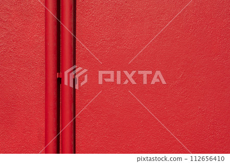 Two red pipes and red rough background .Empty space for text. 112656410